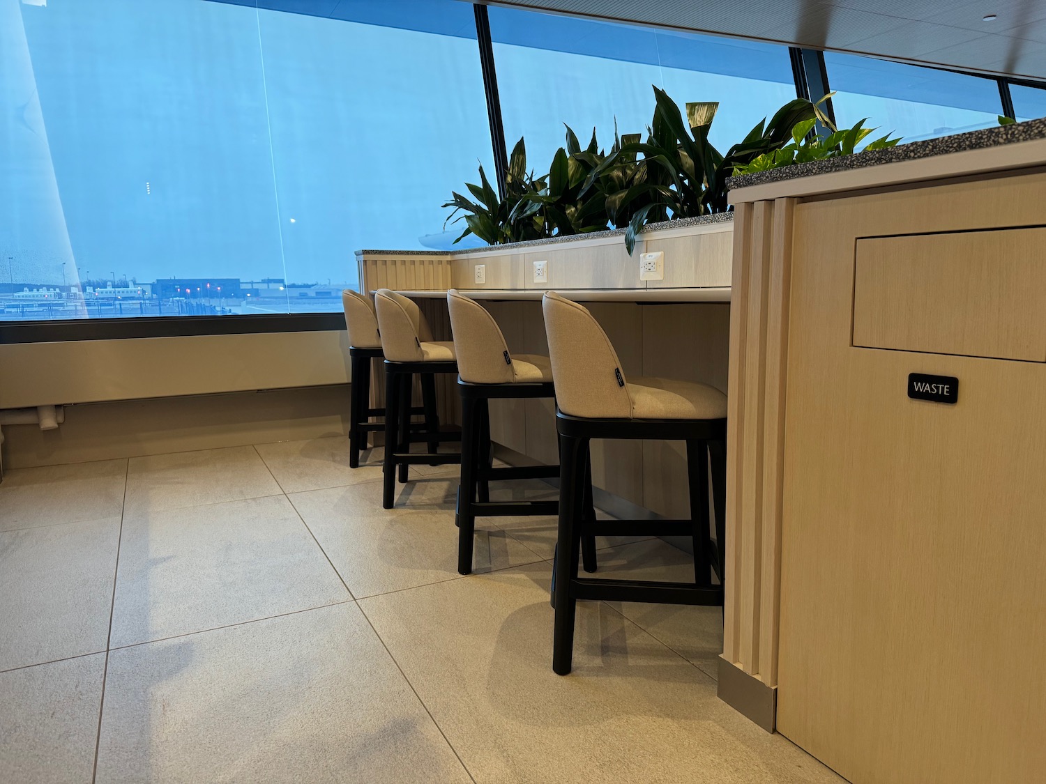 a row of chairs in a room with a window