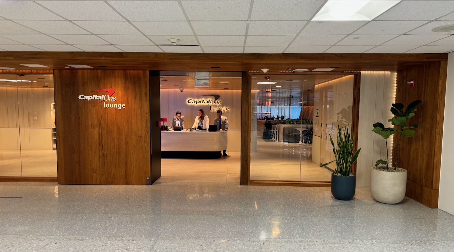 a lobby with a glass door and a sign