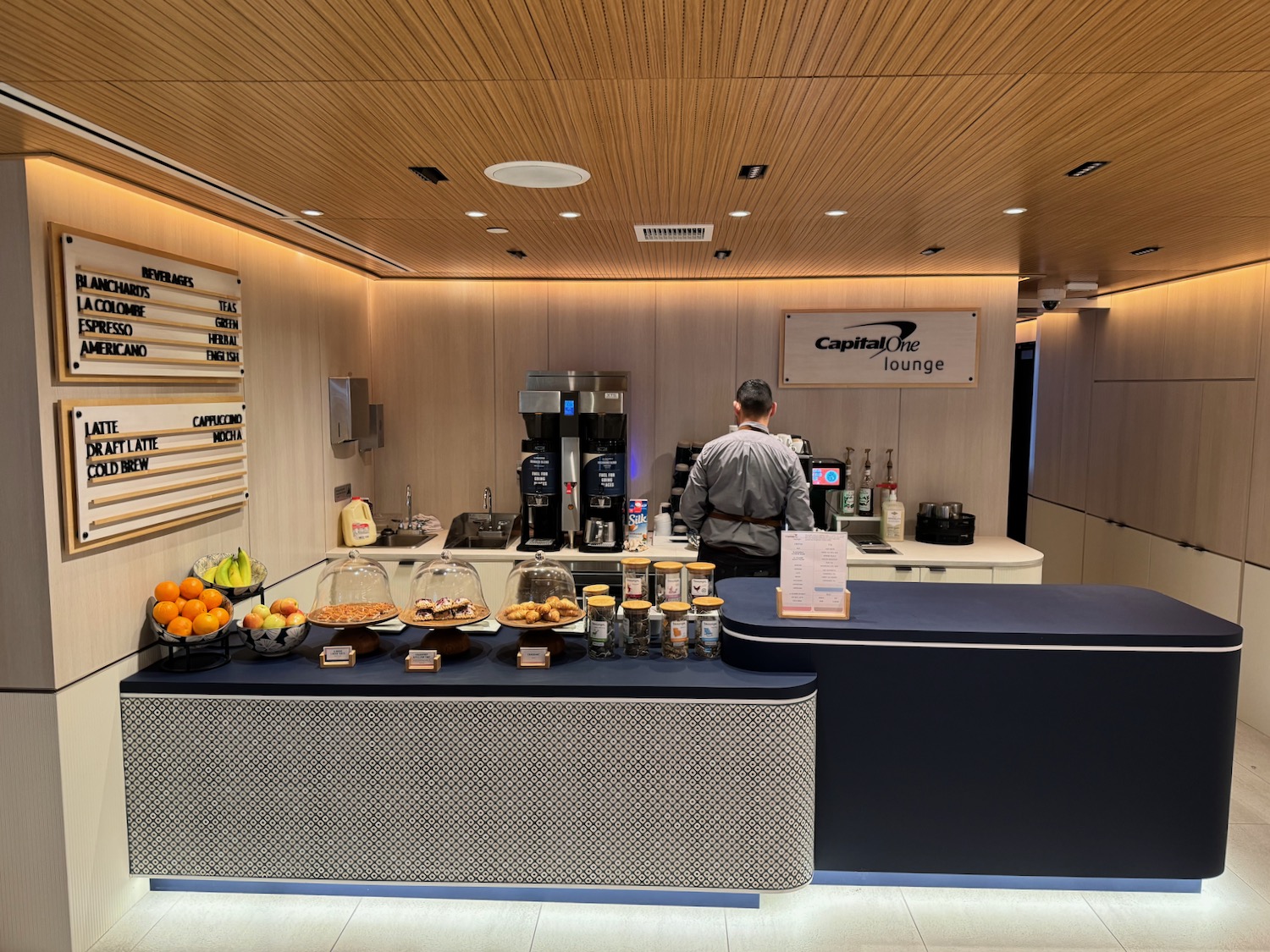 a man standing behind a counter in a restaurant