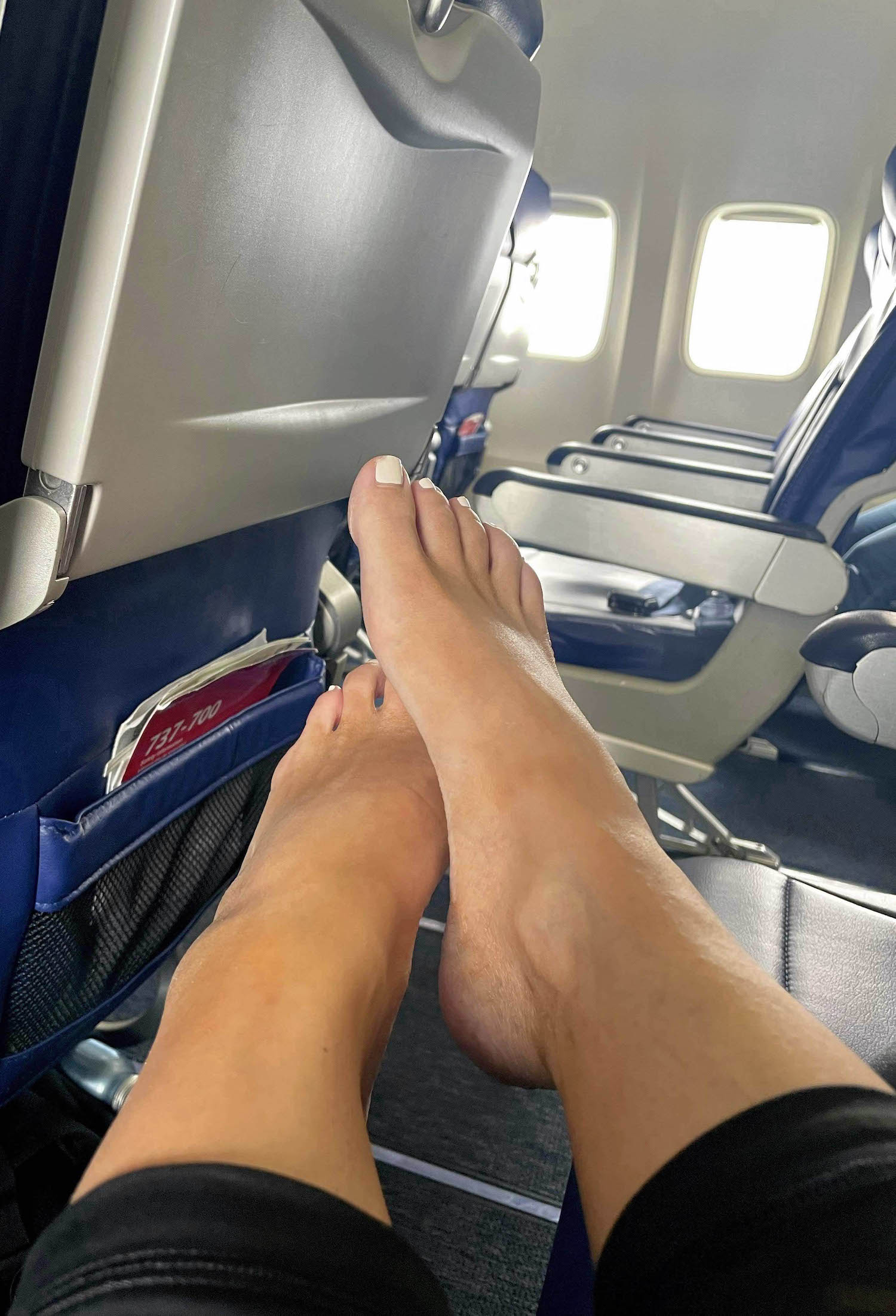a person's feet on an airplane