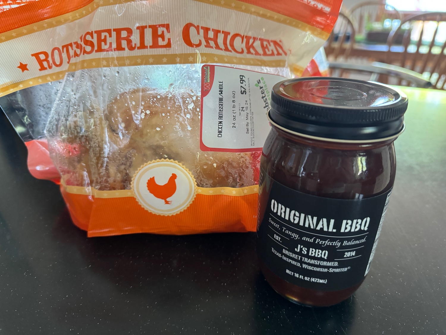 a jar of bbq sauce next to a bag of chicken