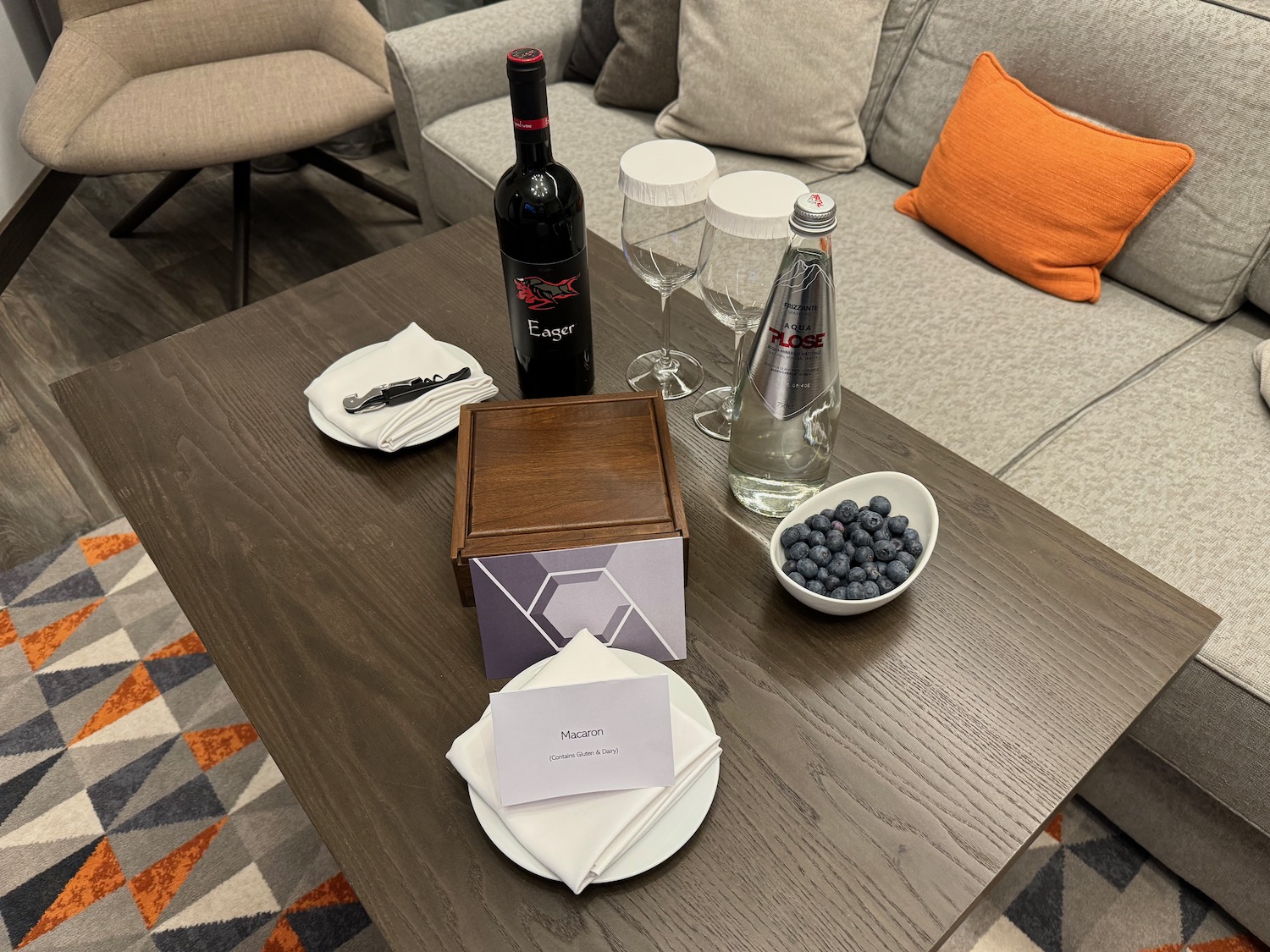 a table with wine bottles and glasses on it