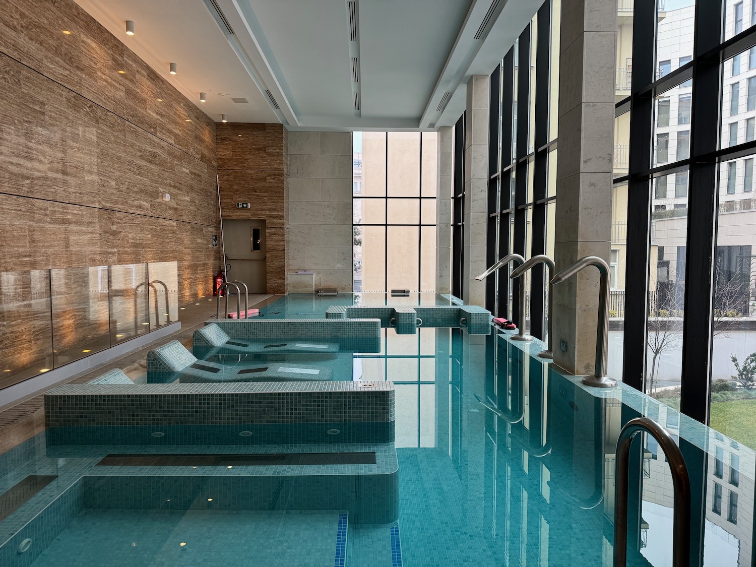 a indoor pool with a large window