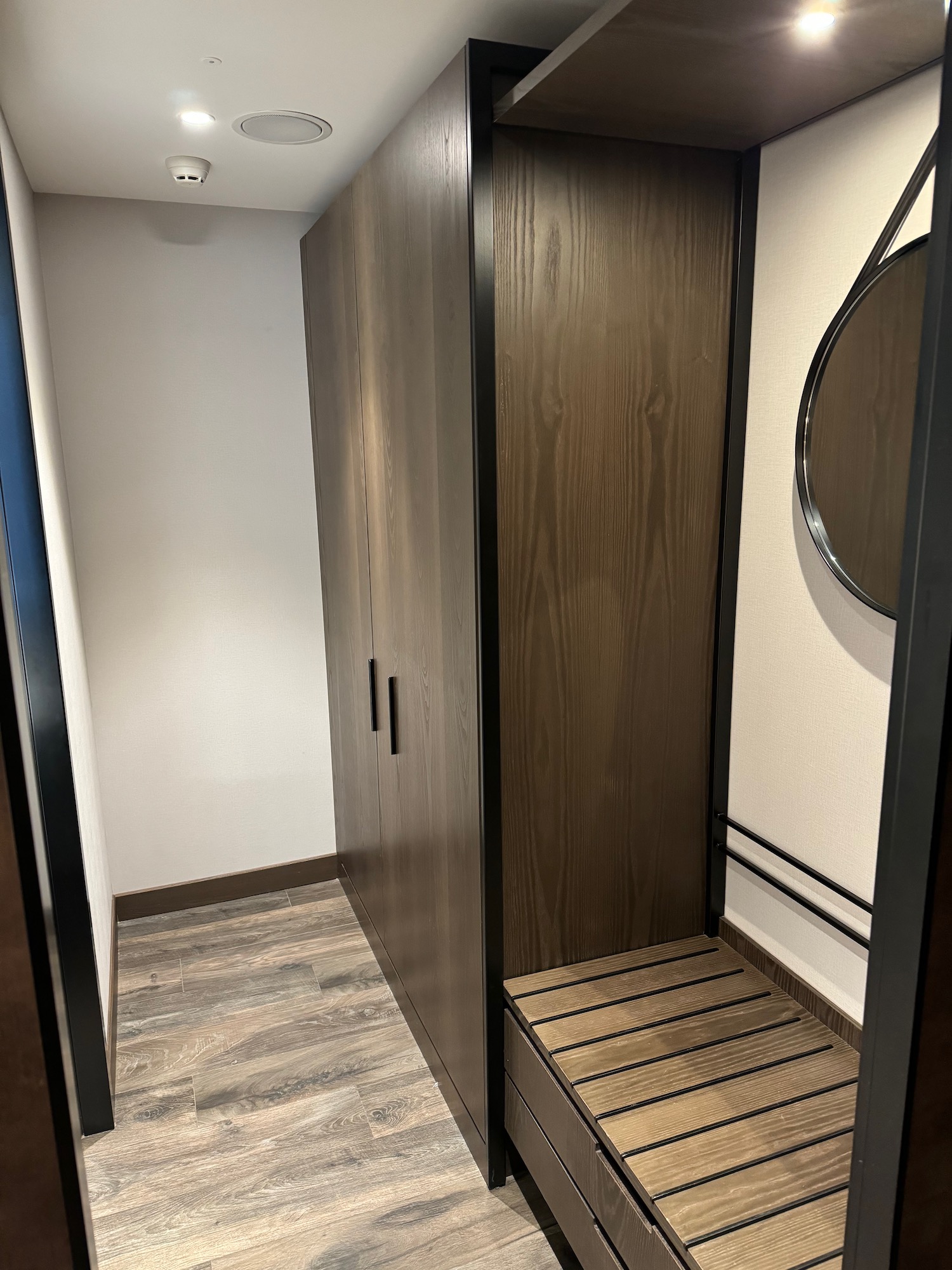 a closet with a mirror and a round mirror