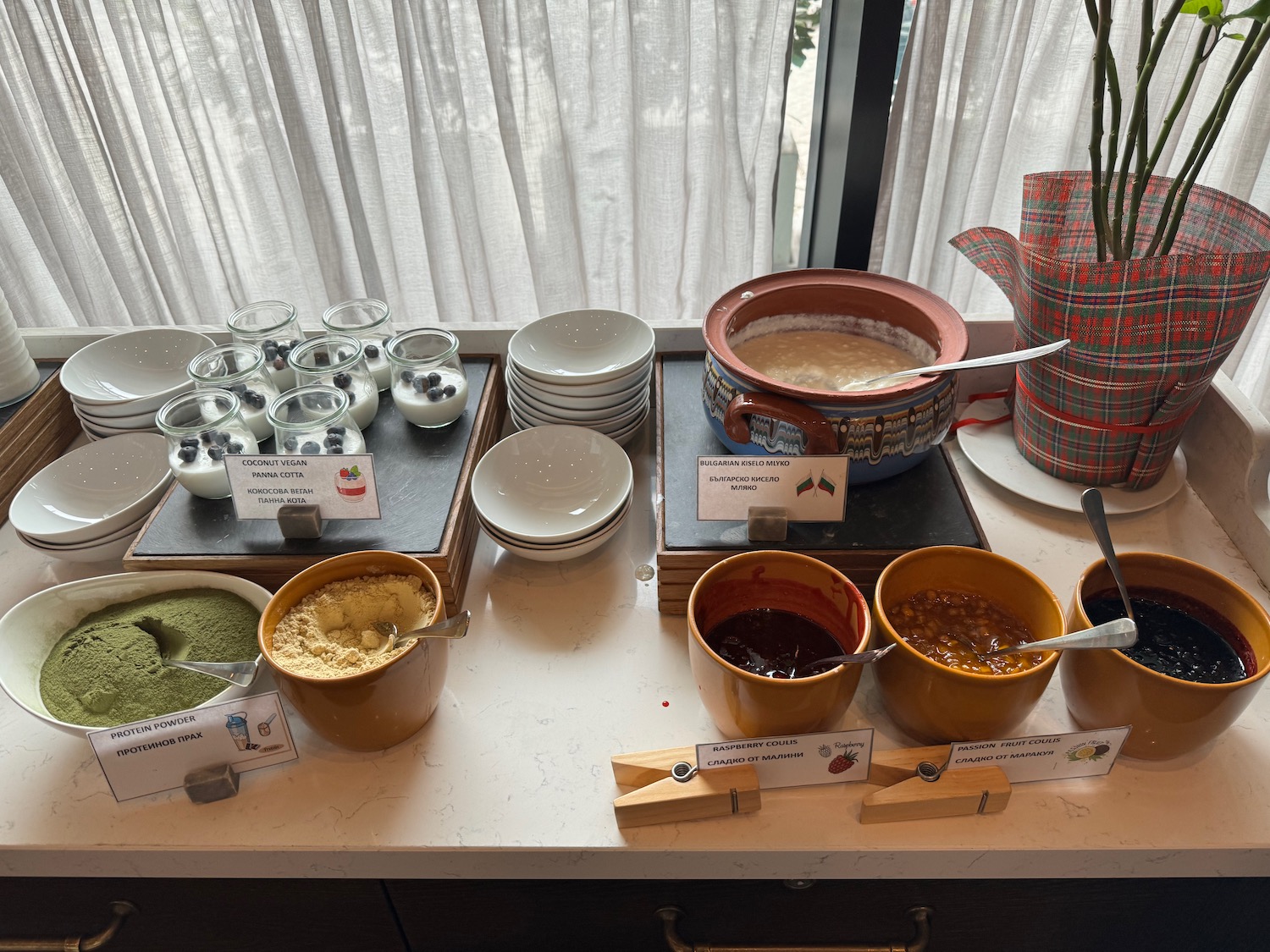 a table with bowls of food and plates