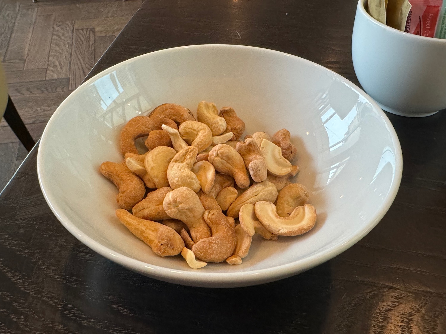 a bowl of cashews and a cup of coffee