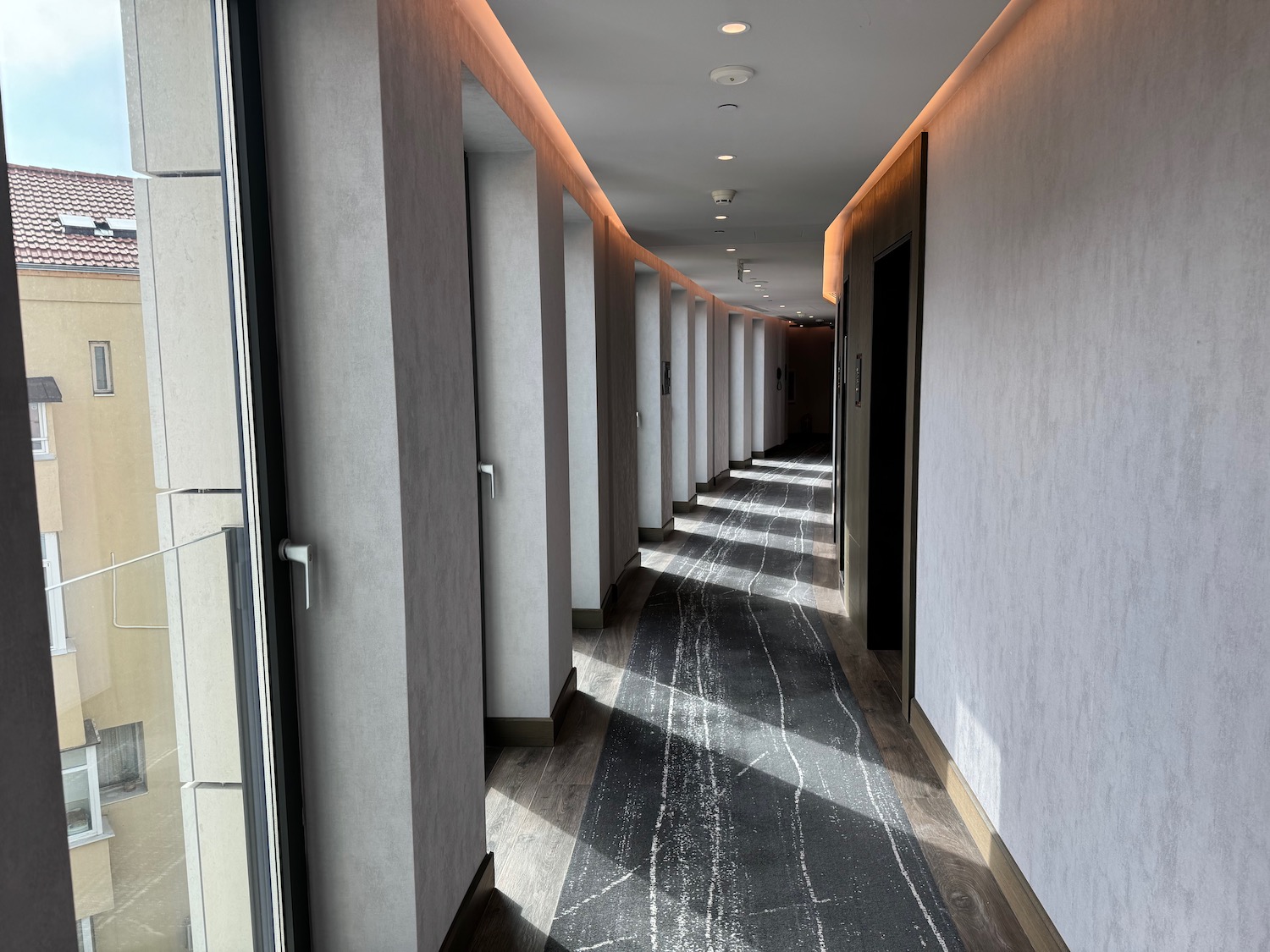 a hallway with many white pillars