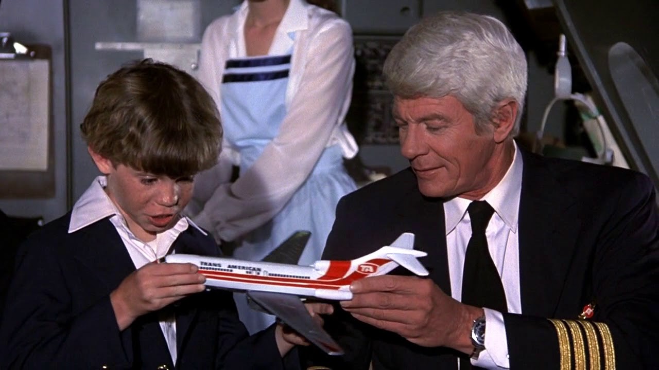 a man and boy holding a model airplane