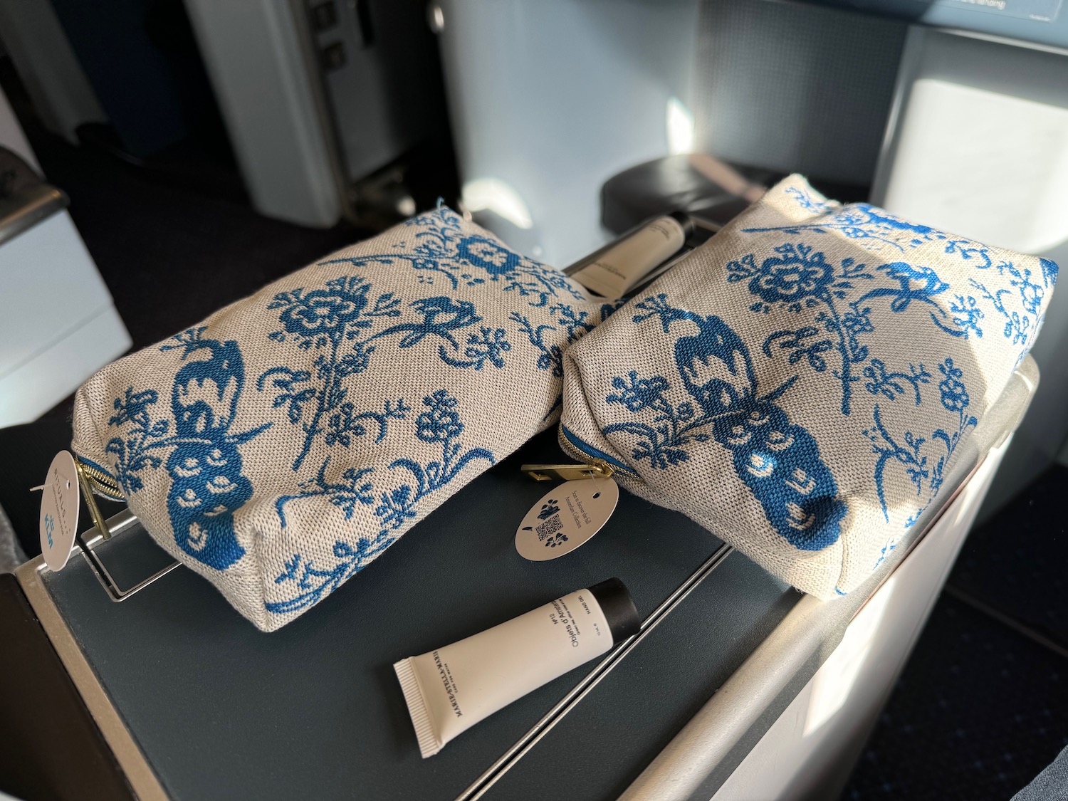 two bags with a floral design on a table