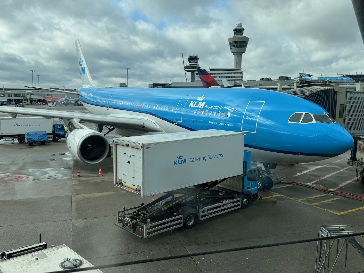 a blue airplane at an airport