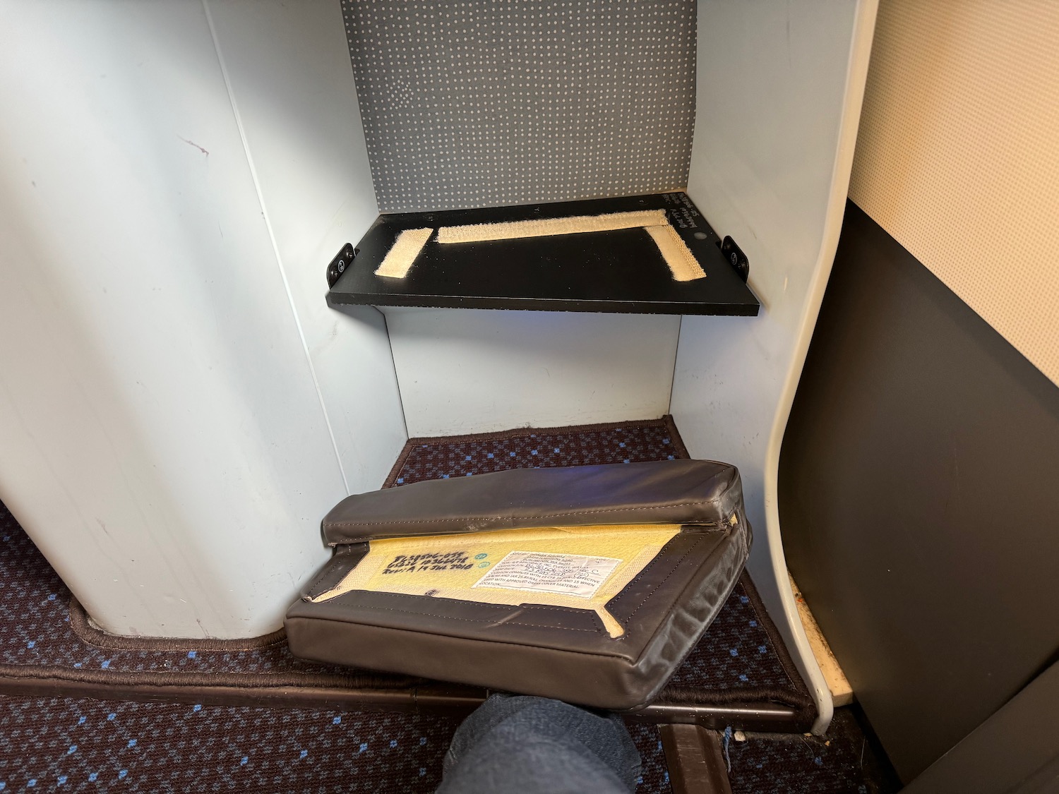 a two black shelves in a small room