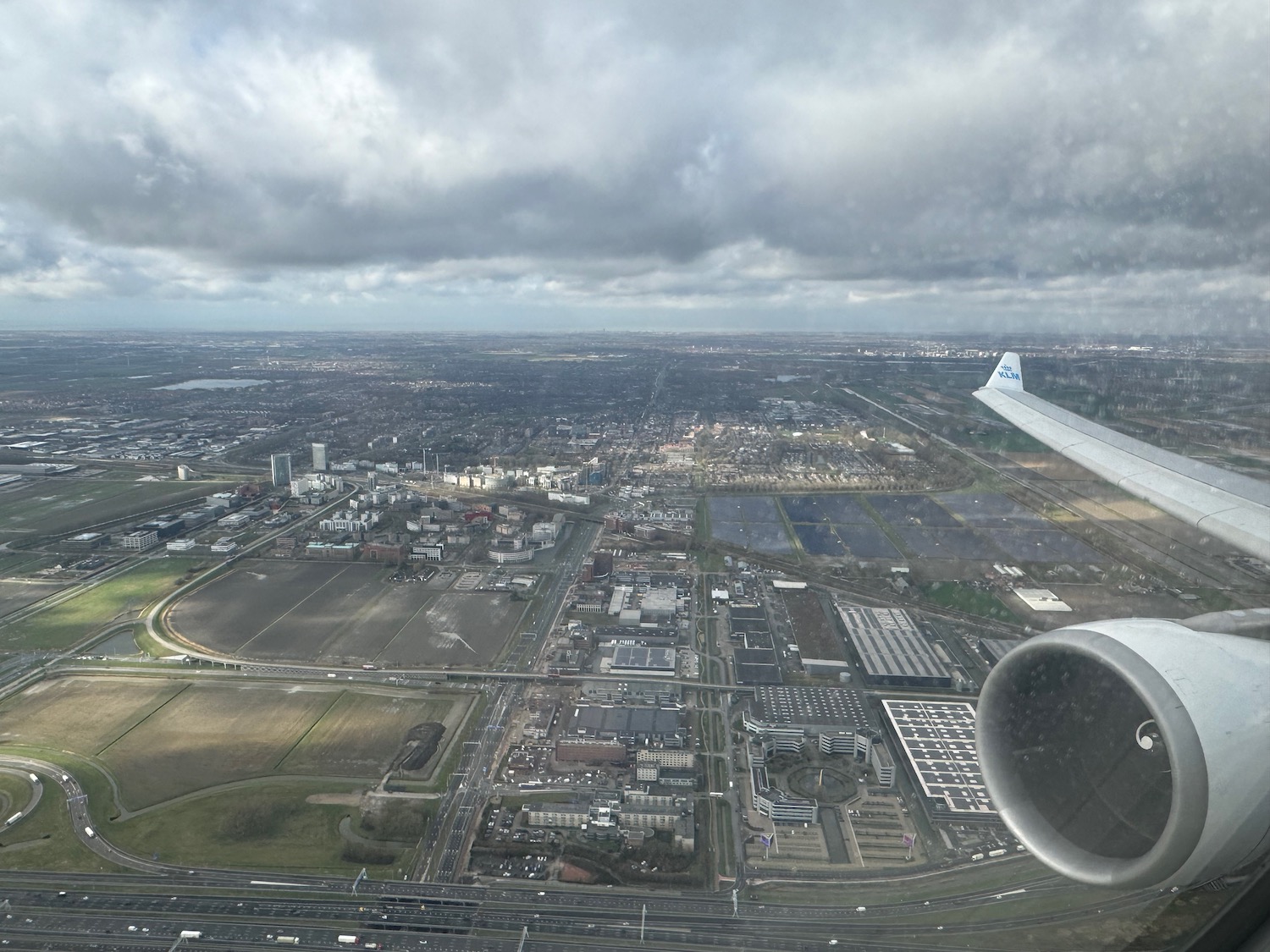 an airplane wing and a city