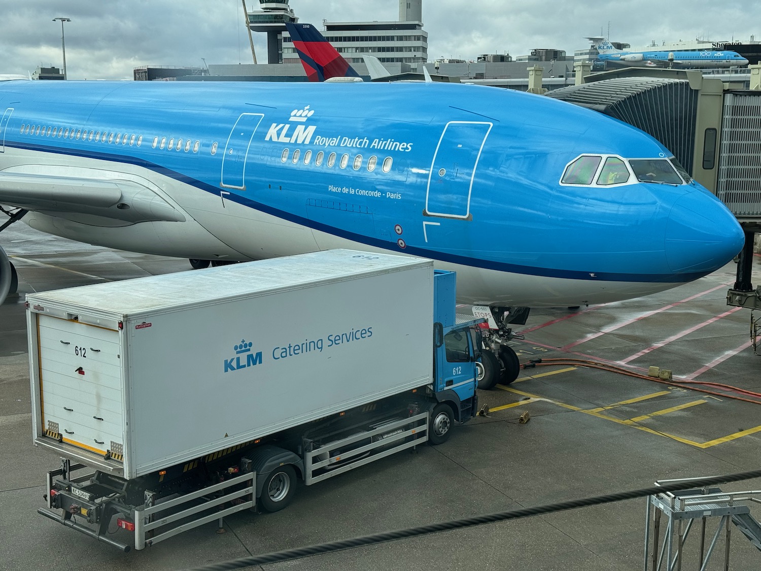 a blue airplane parked at an airport