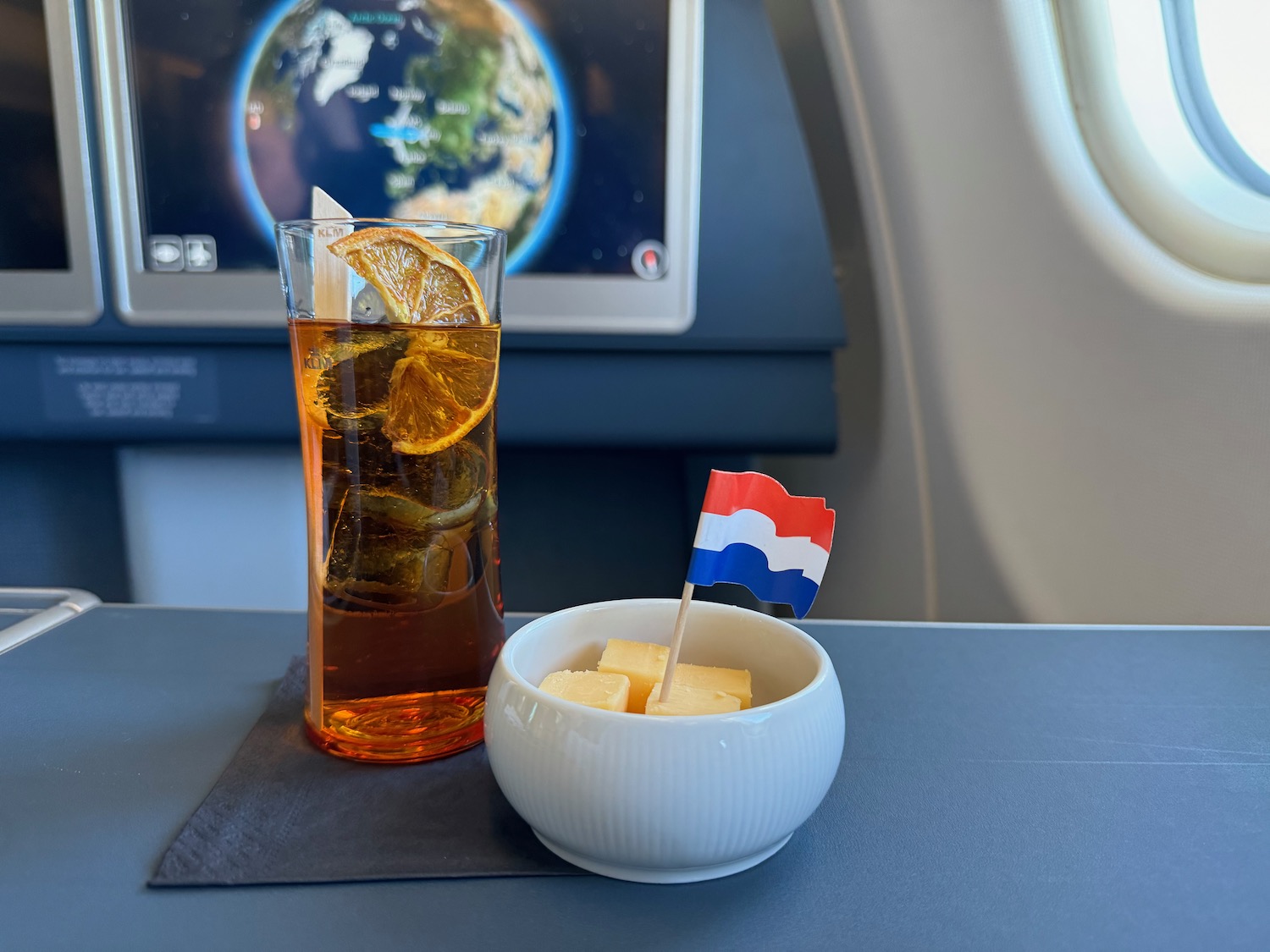 a glass of tea with a small flag in a bowl