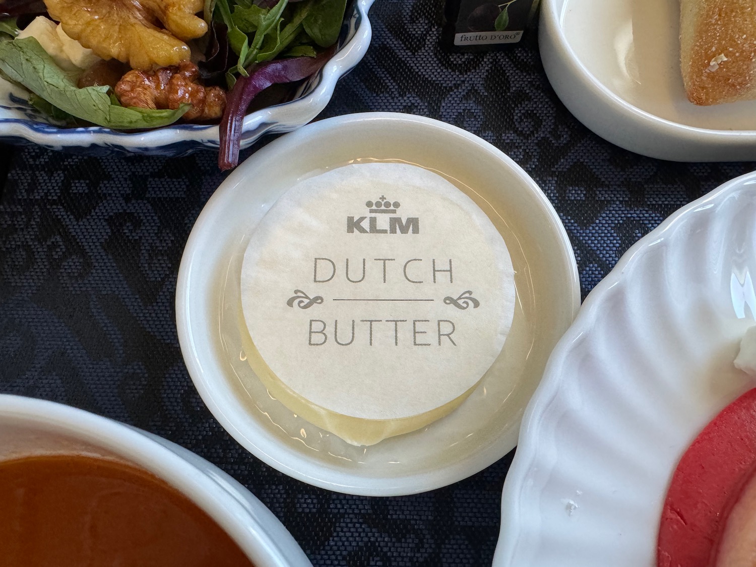 a plate of butter with a round piece of butter on it