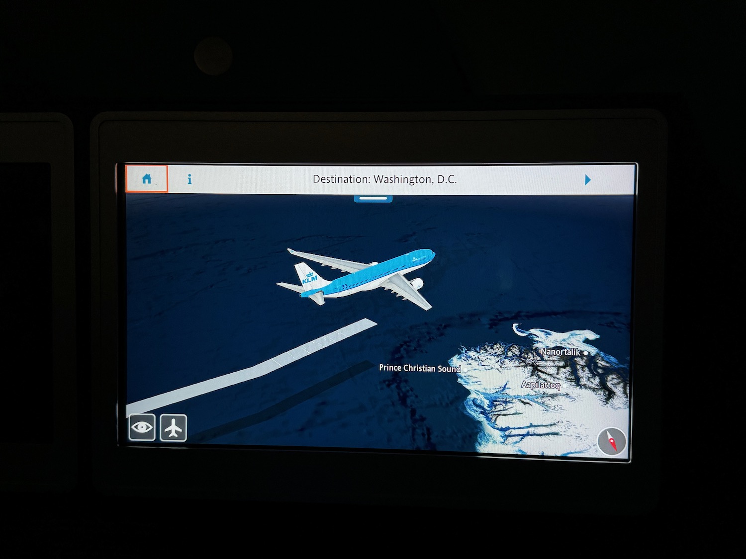 a screen with an airplane flying over the ocean