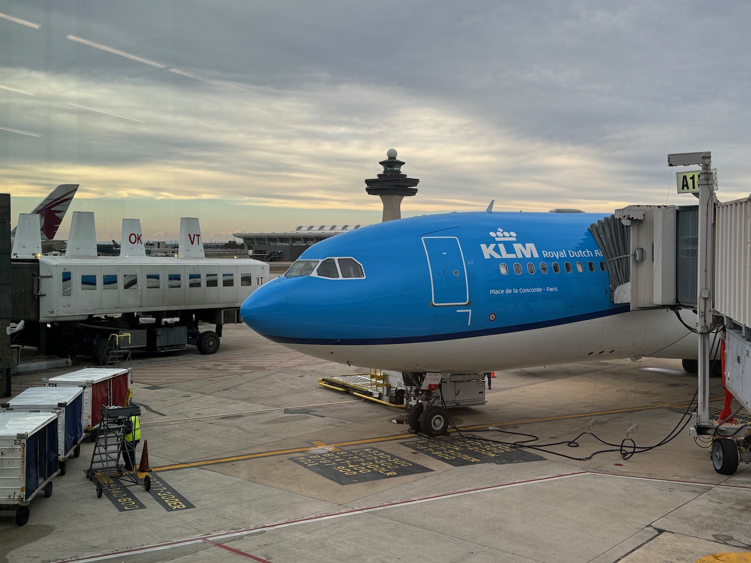 a blue airplane on a runway