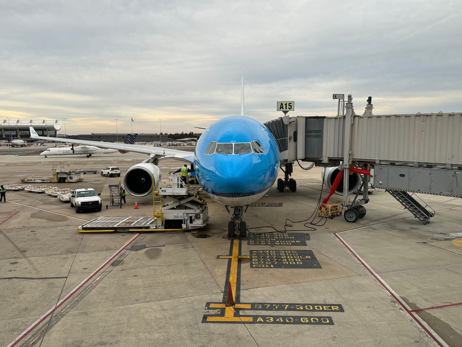 a blue airplane at an airport