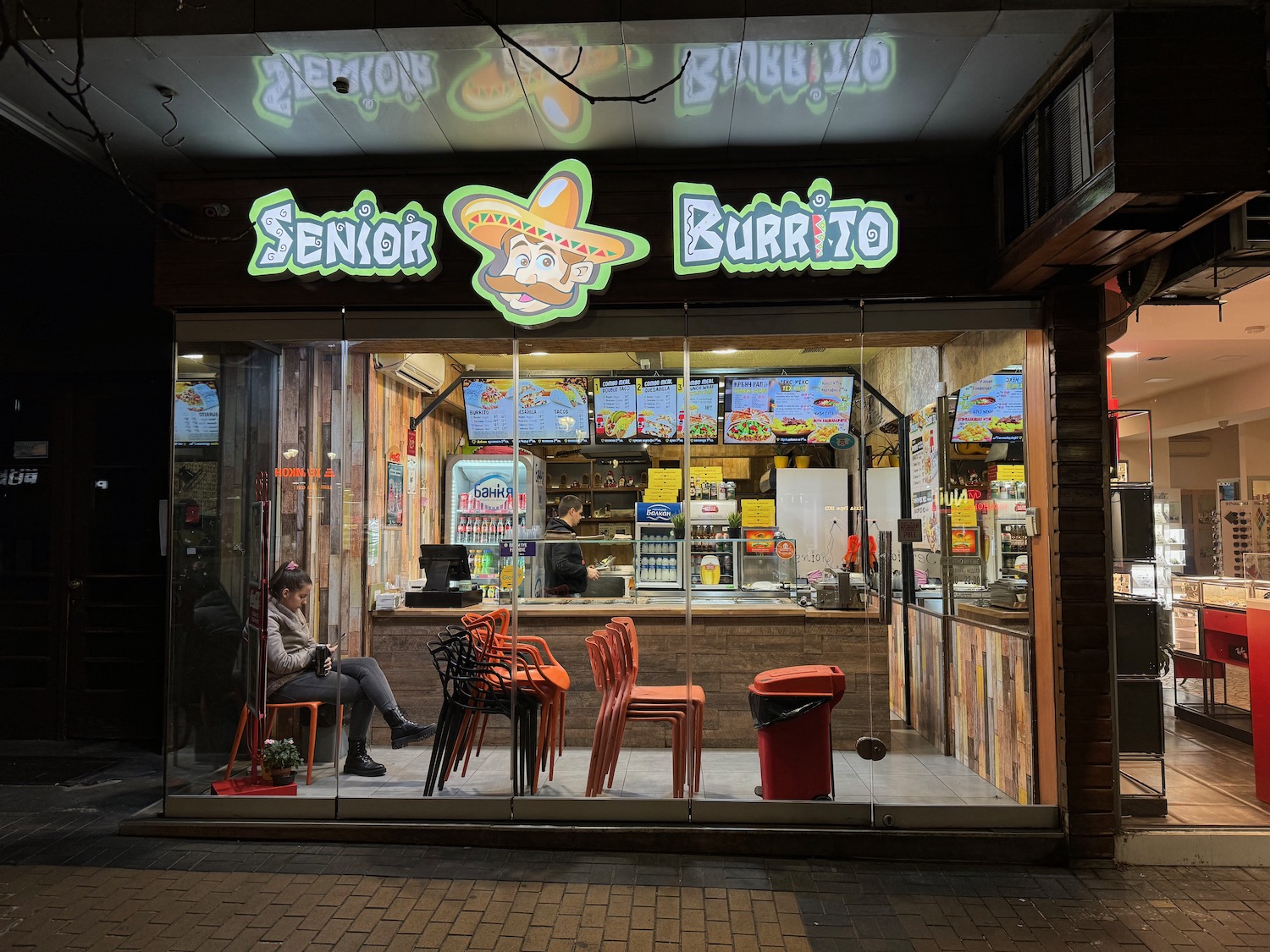 a restaurant with a person sitting in a chair