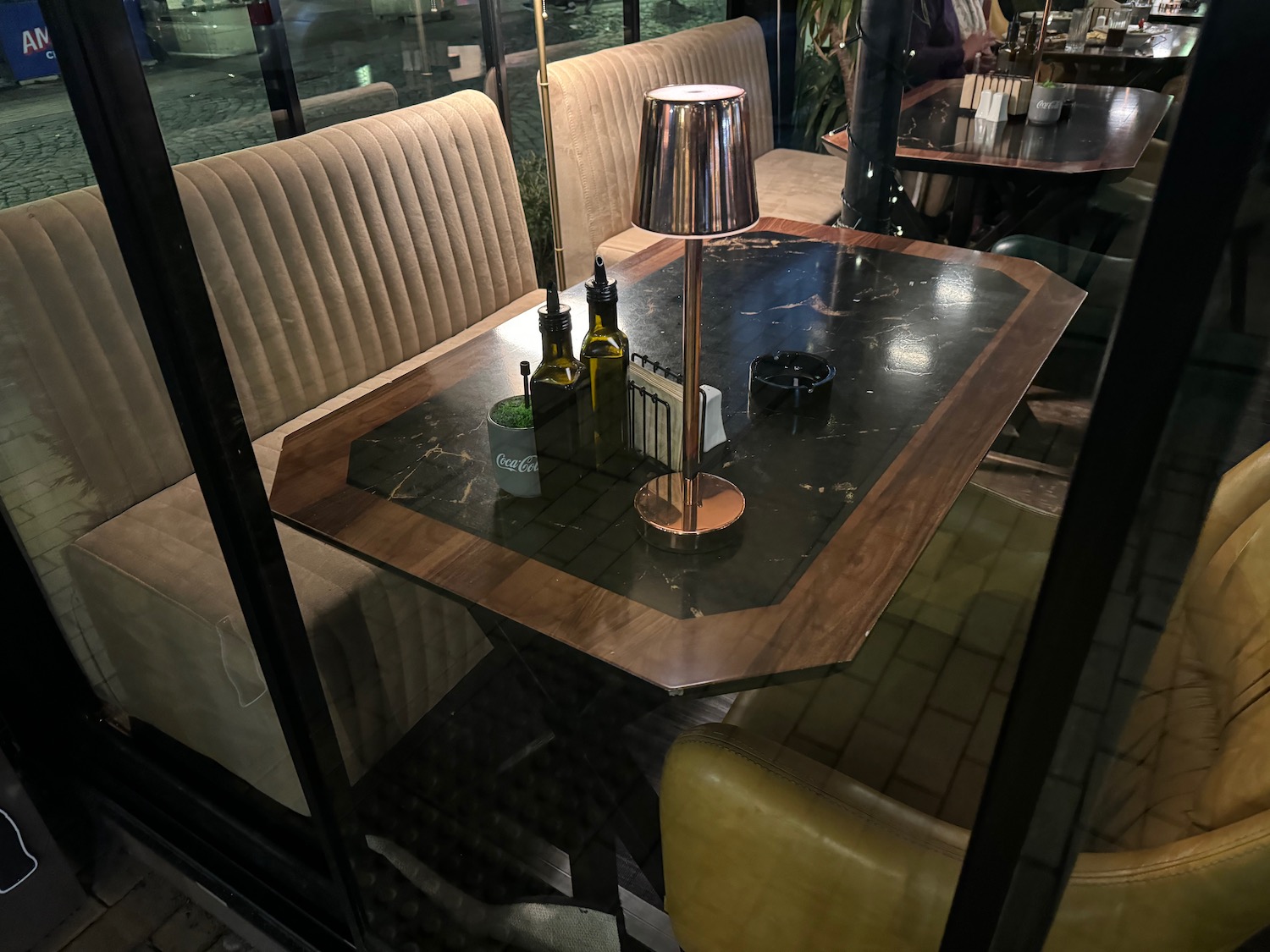 a table with a lamp and bottles on it