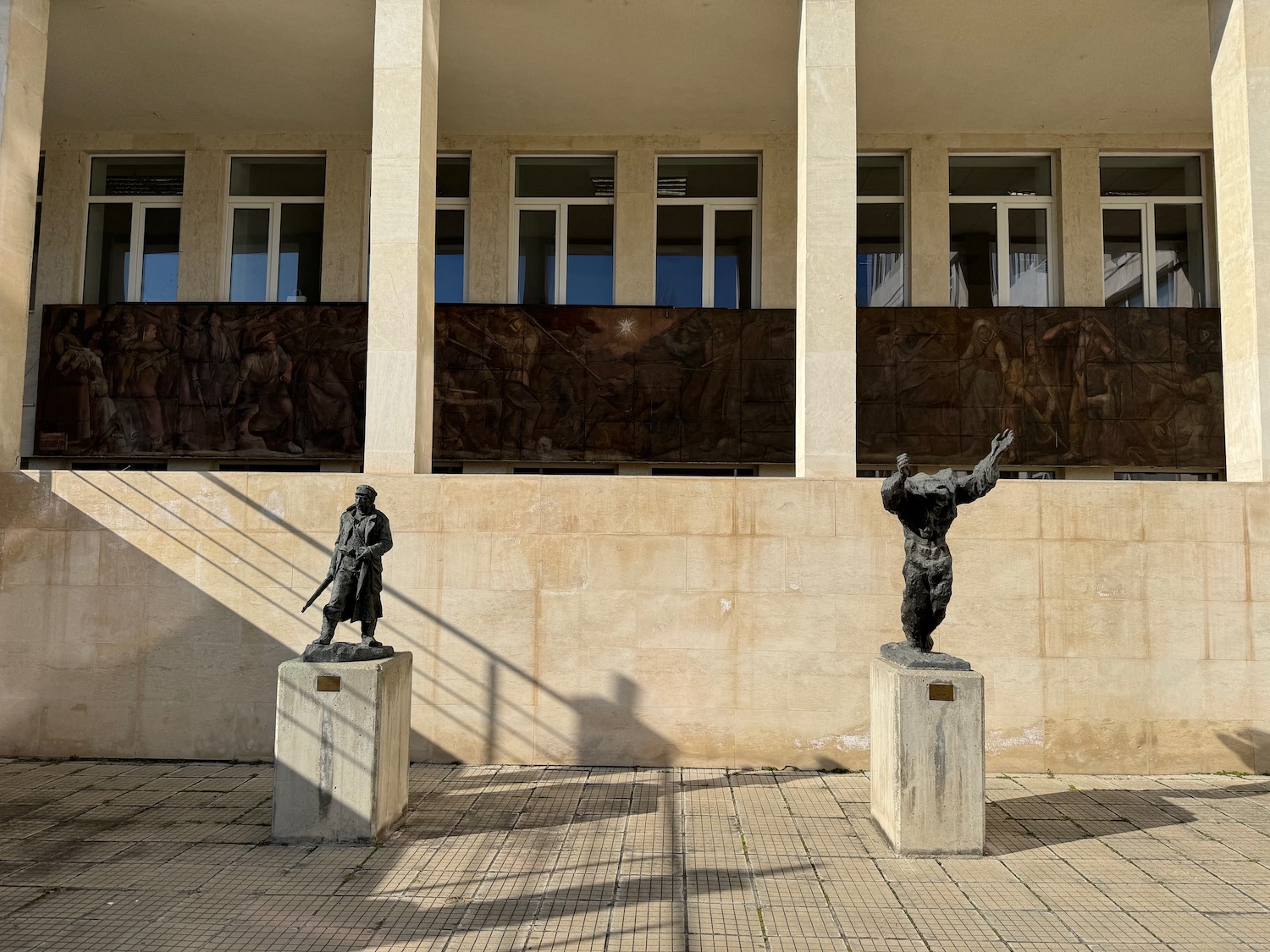 statues on pedestals outside of a building