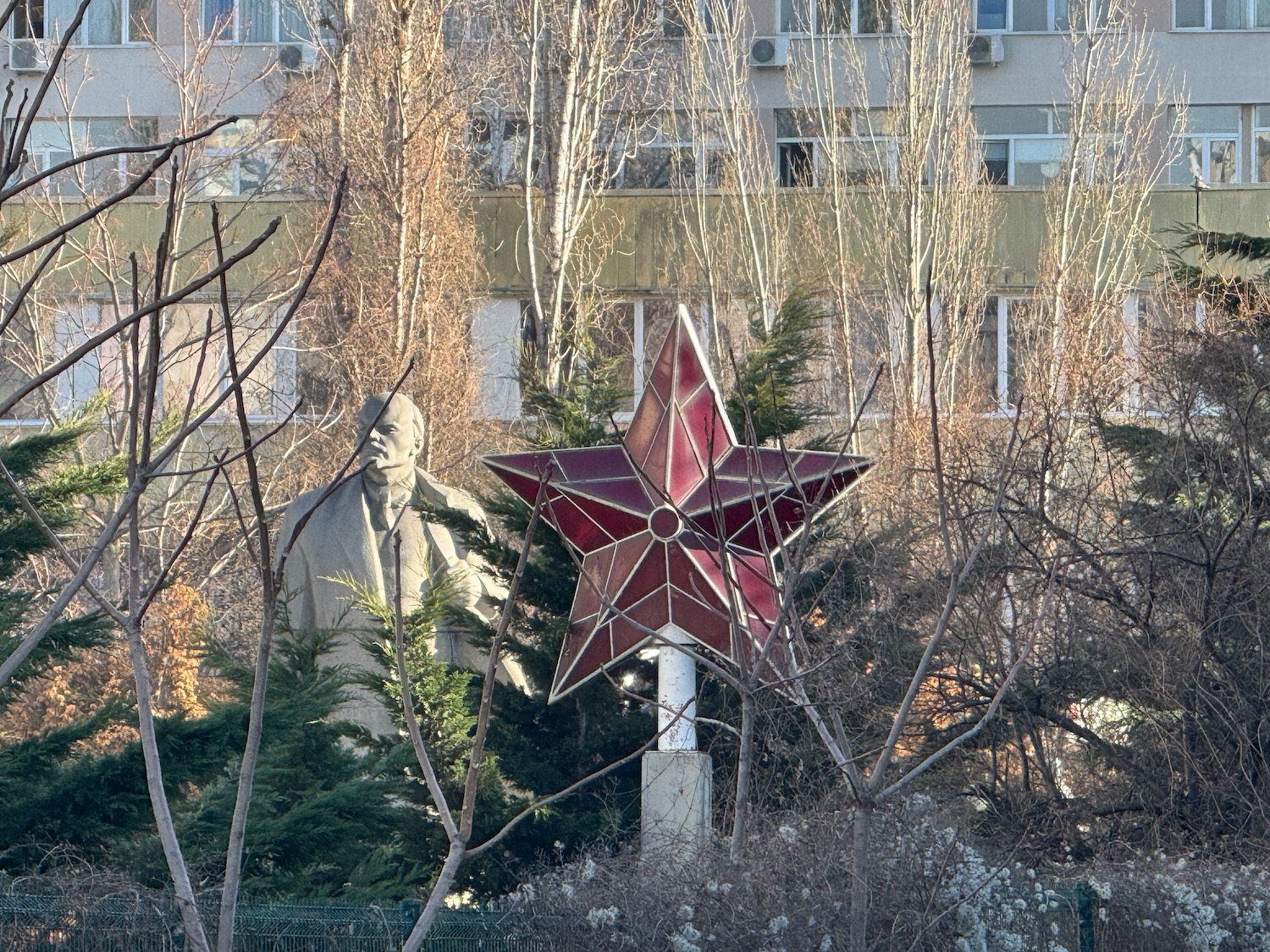 a statue of a man and a star in front of a building