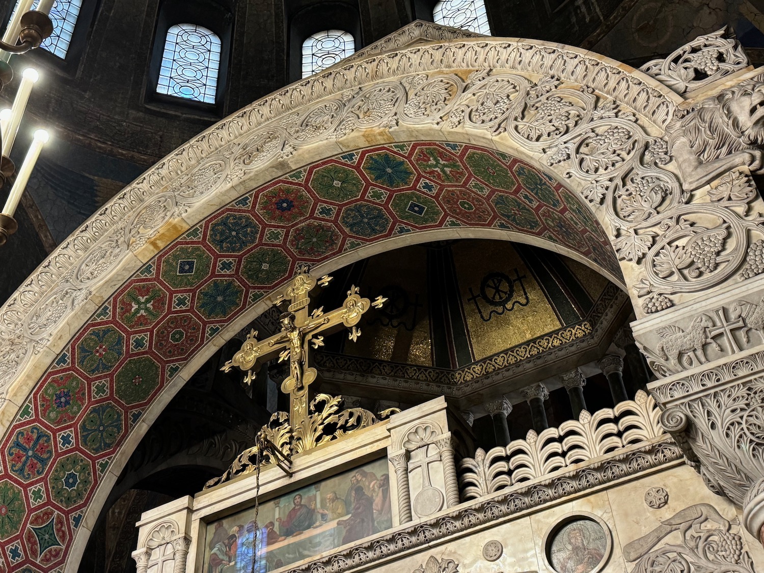 a ornate stone arch with a cross