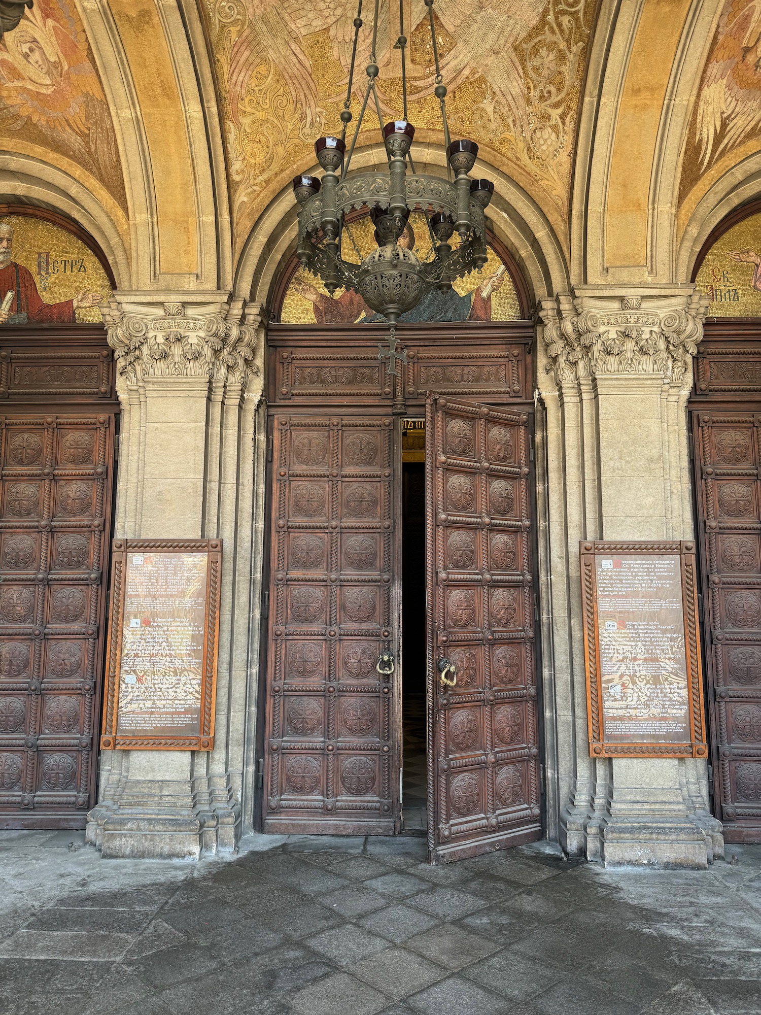 a large wooden doors with a chandelier