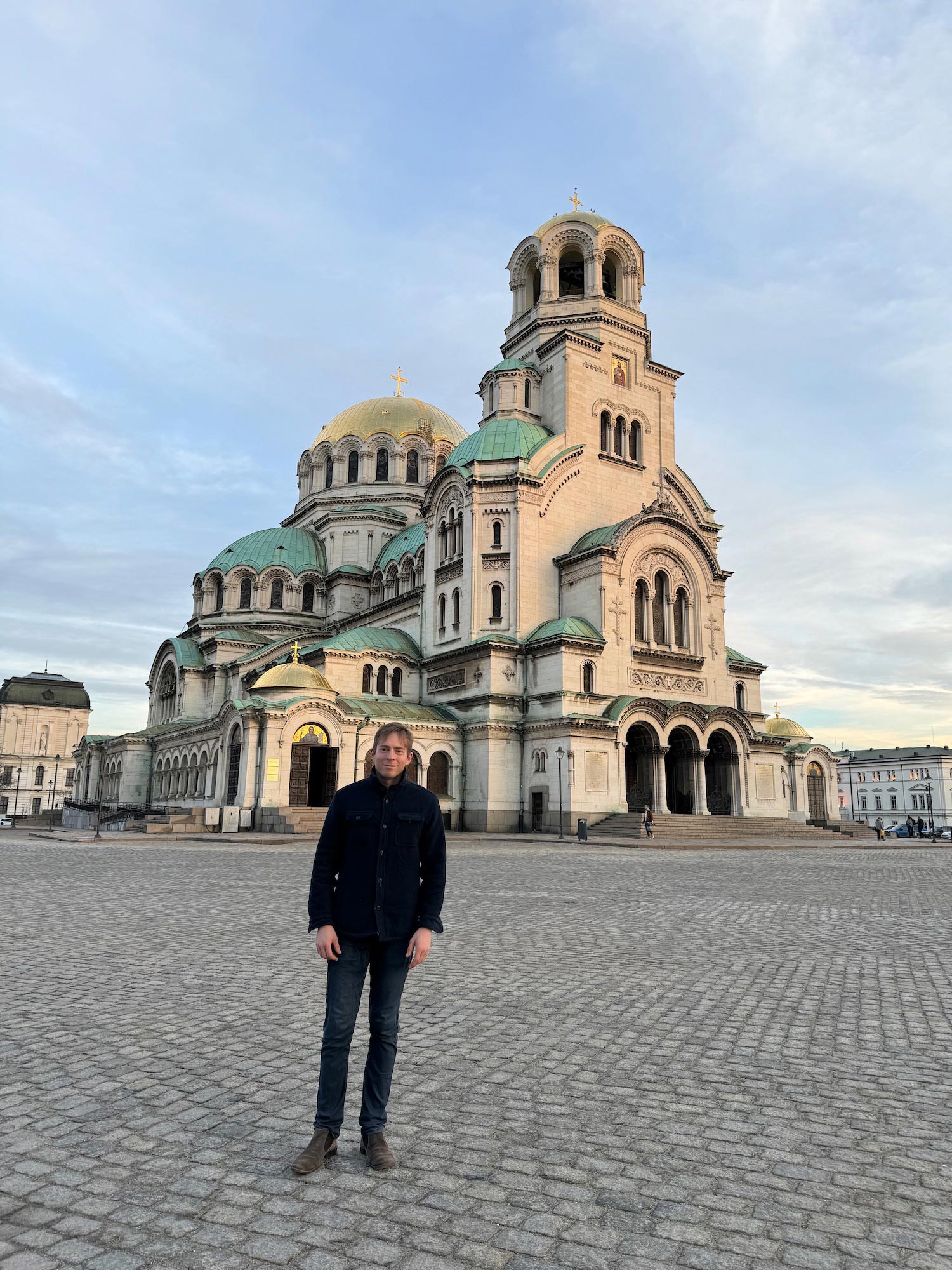 a man standing in front of a large building