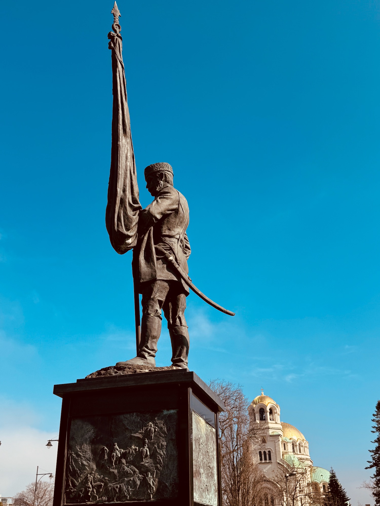 a statue of a man holding a flag