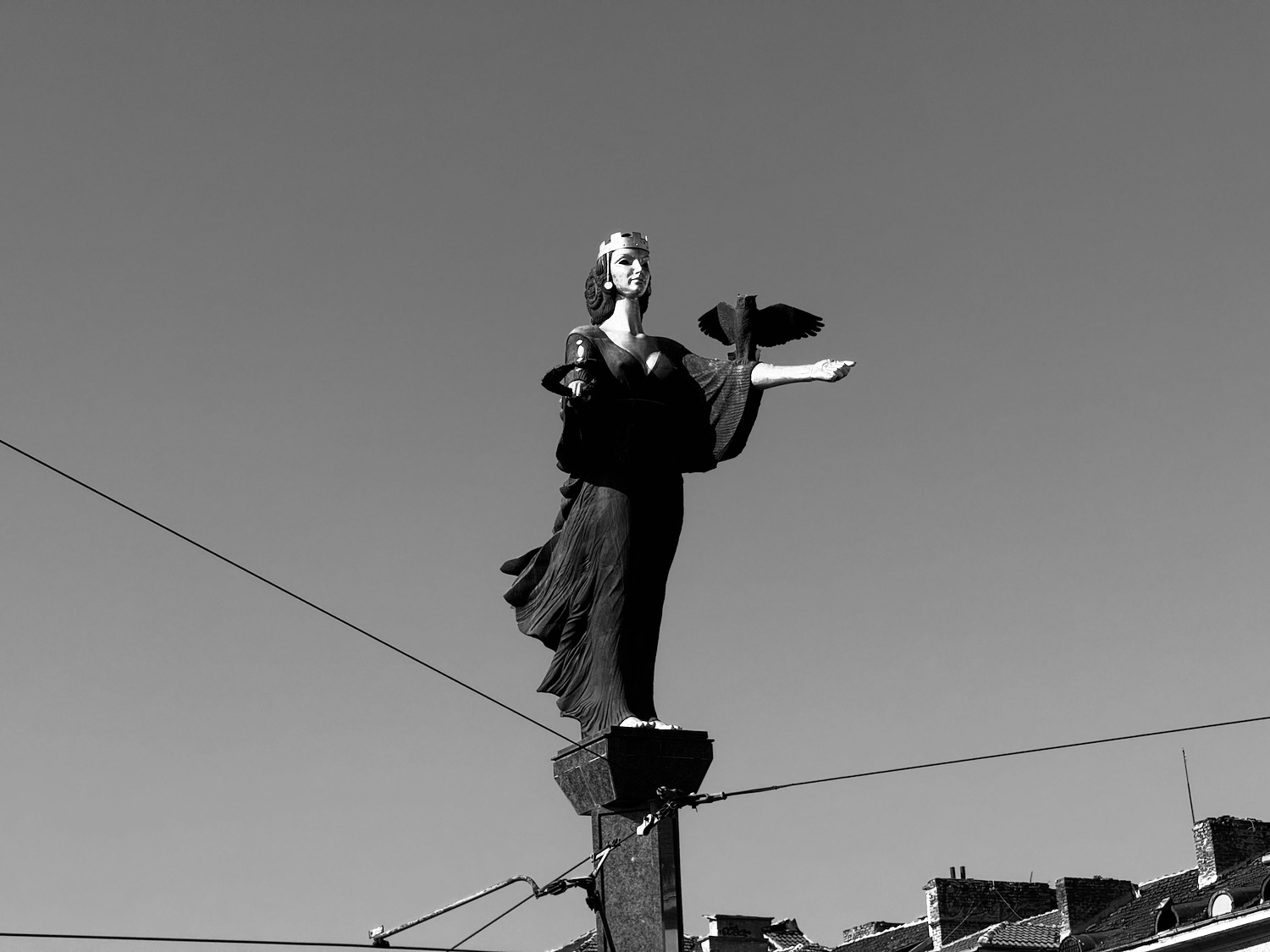 a statue of a woman holding a bird