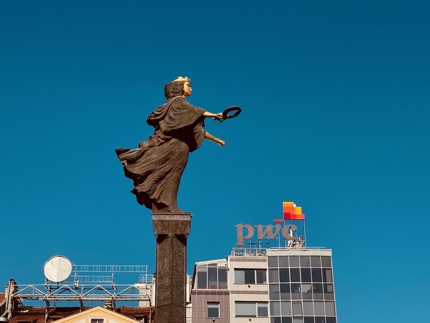 a statue of a woman holding a circle