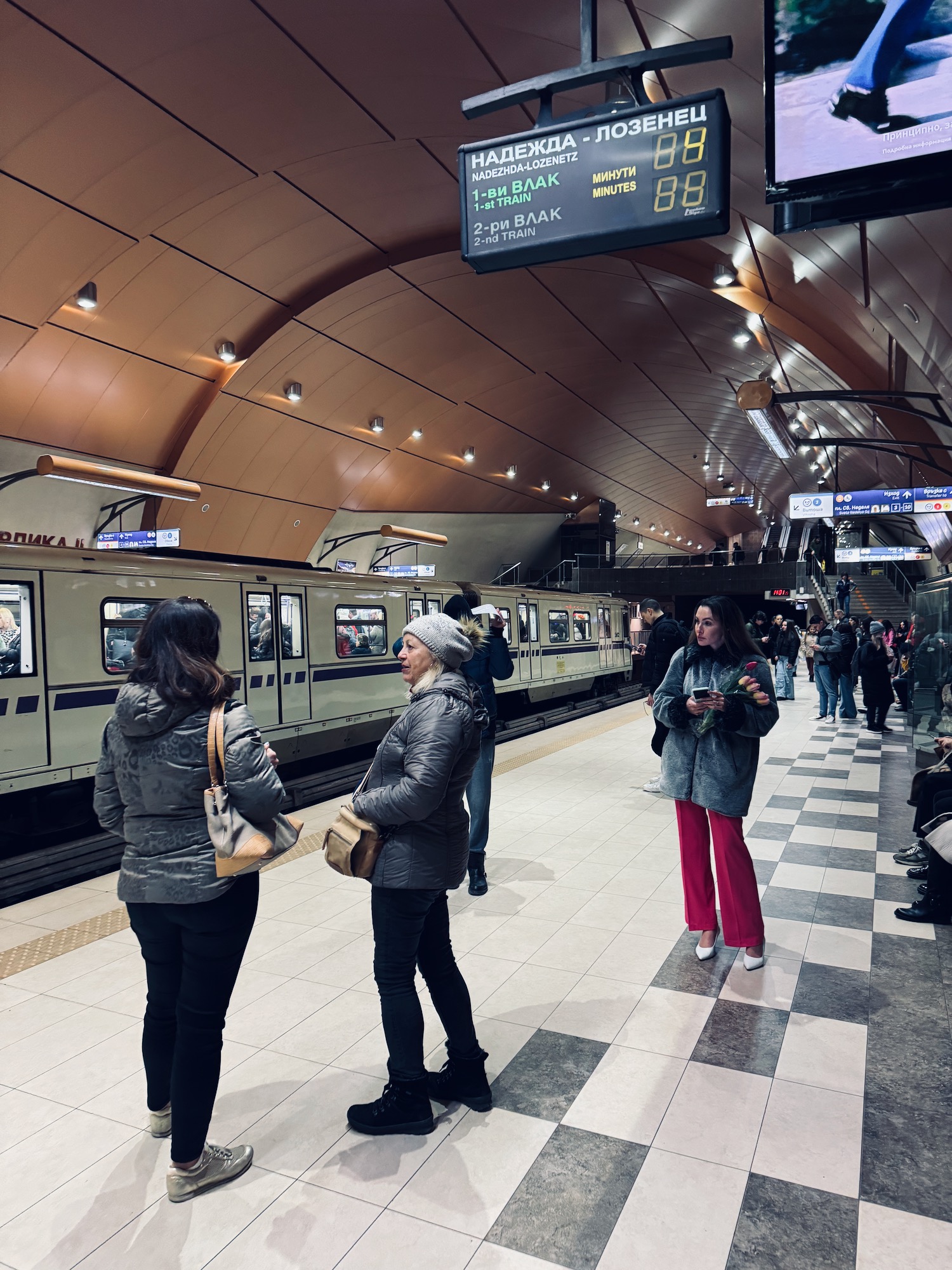 a group of people standing in a train station