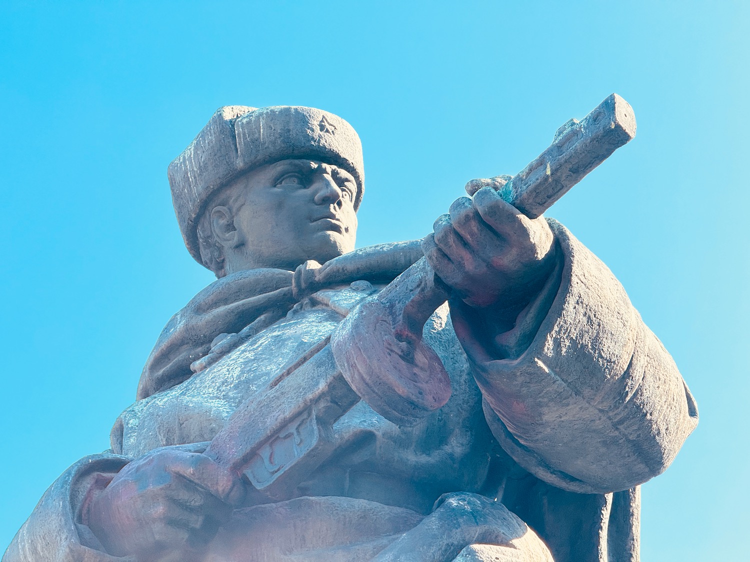 a statue of a man holding a gun