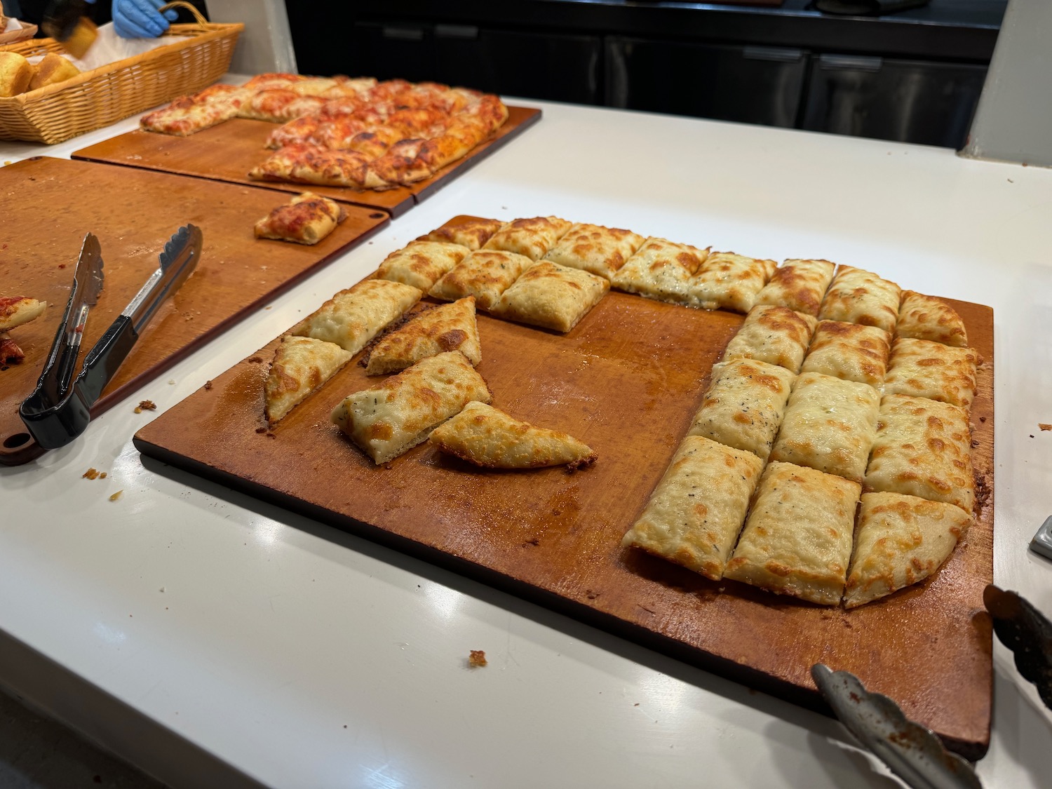 a trays of pizza on a counter