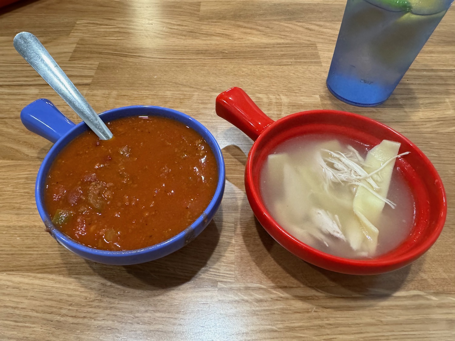 two bowls of soup and a cup of water