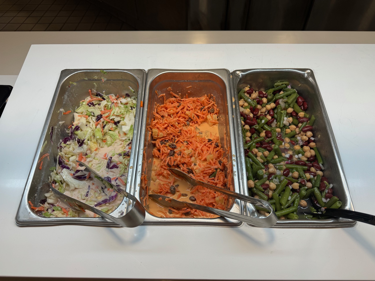 a row of metal containers with food in them