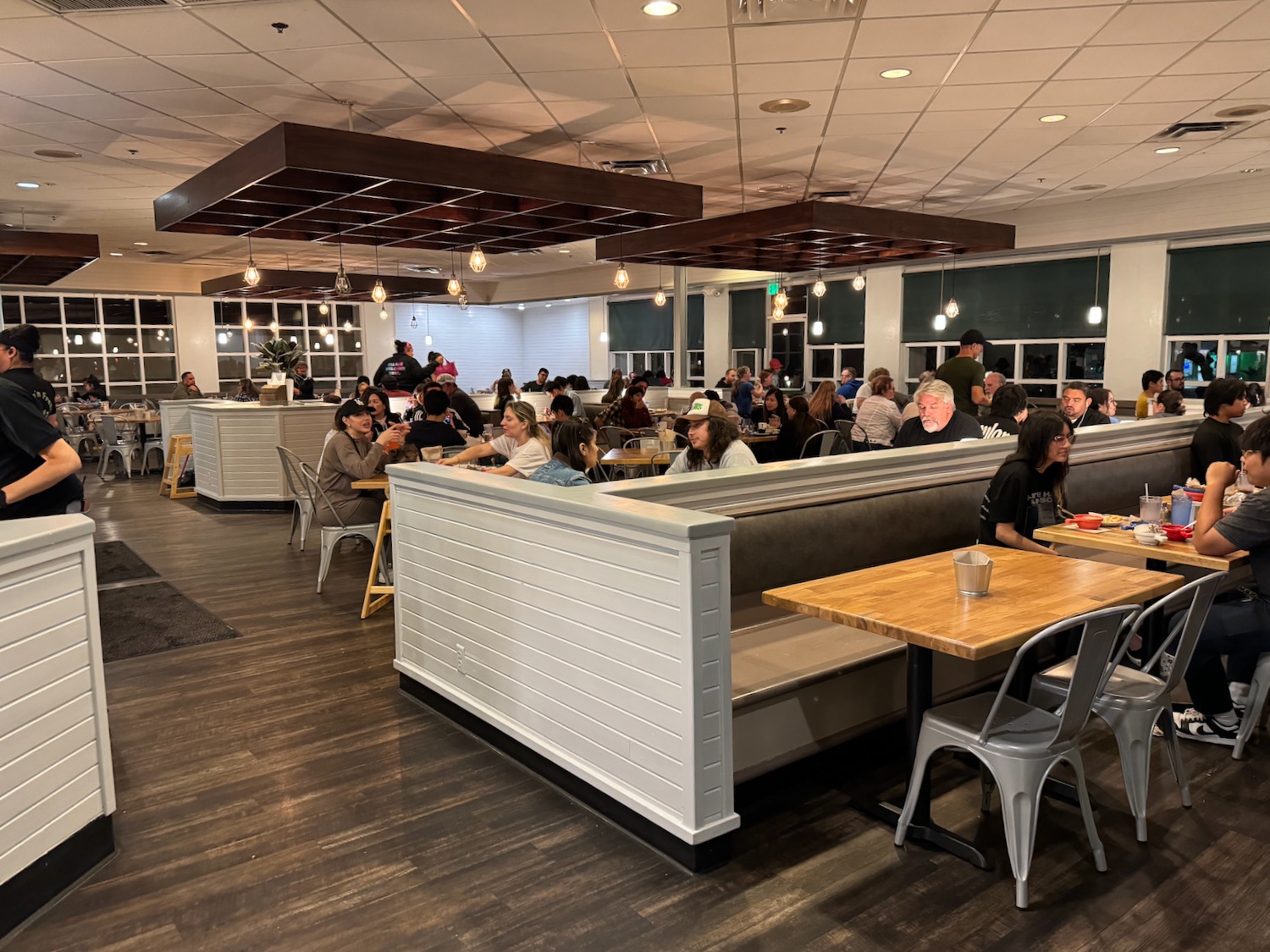 a group of people sitting at tables in a restaurant