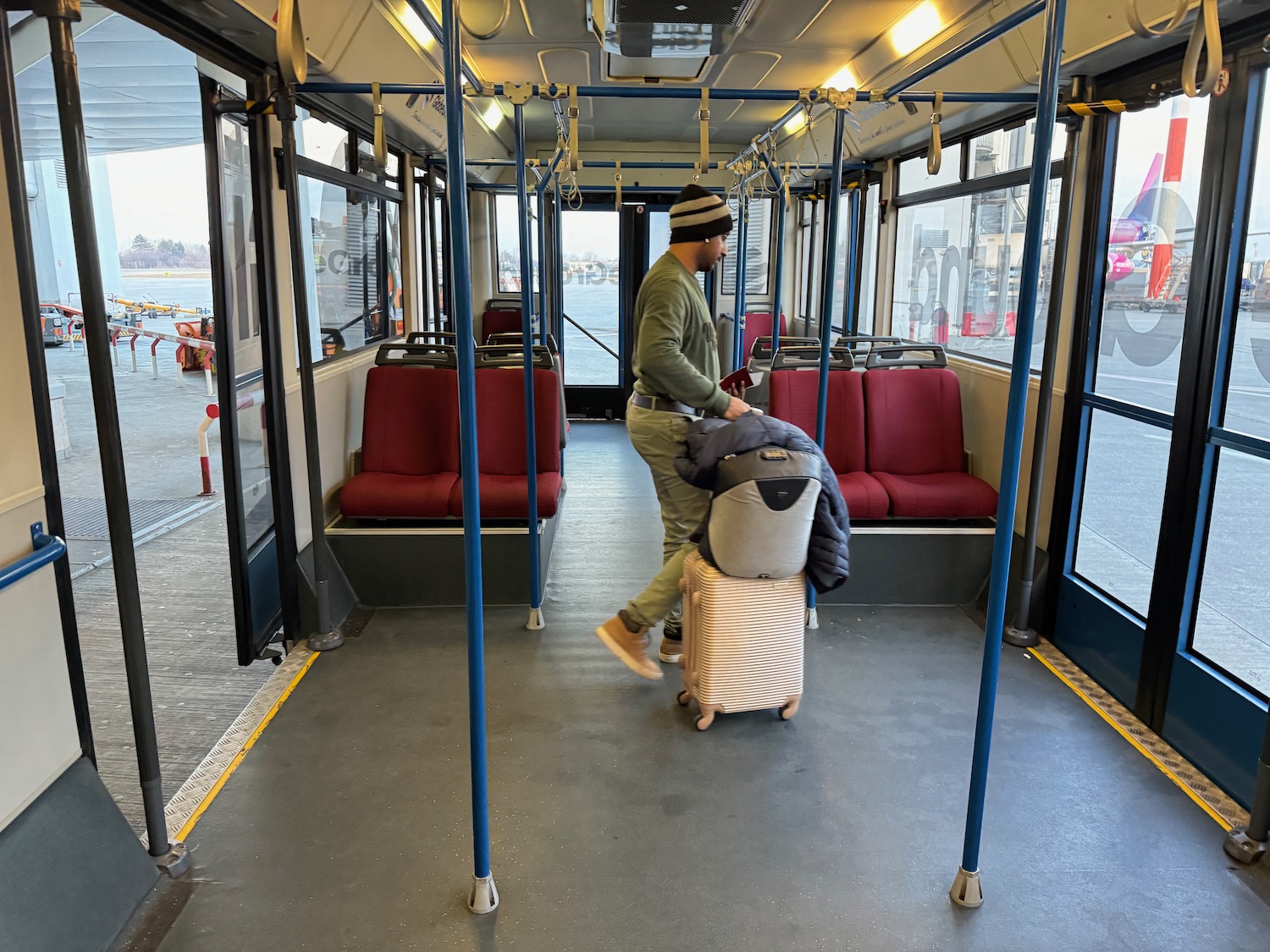 a man pushing a luggage on a bus