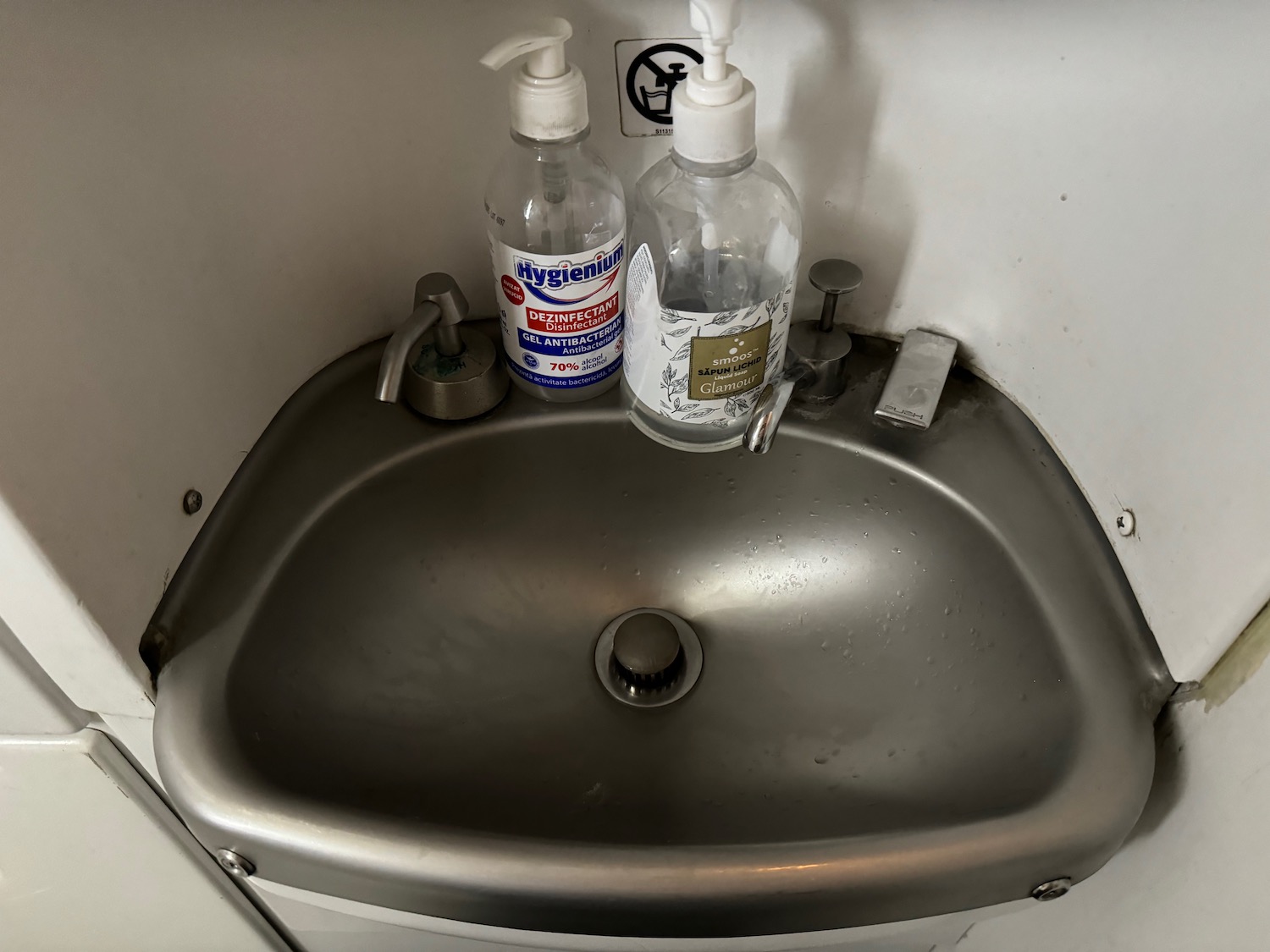 a sink with soap dispensers and bottles