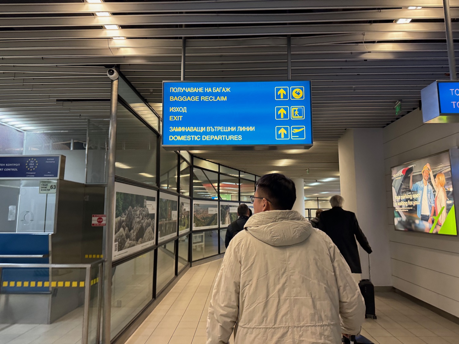 a man walking in a building with a sign