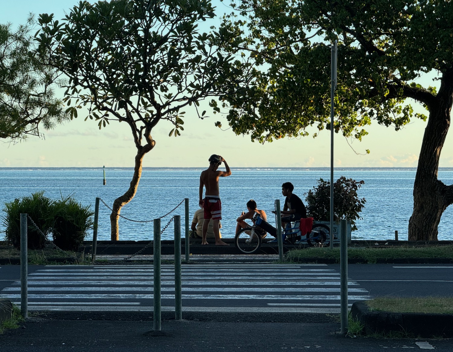 a group of people sitting on a bench near a body of water