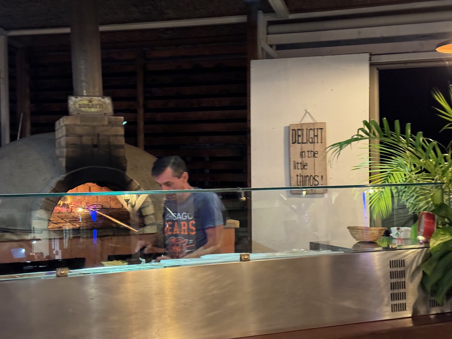 a man standing behind a glass counter