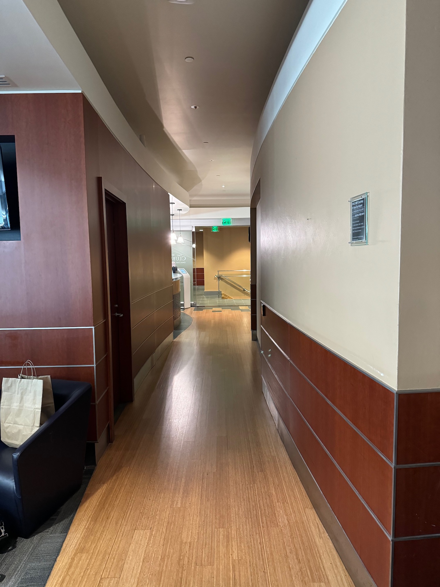 a hallway with wood walls and a wood floor