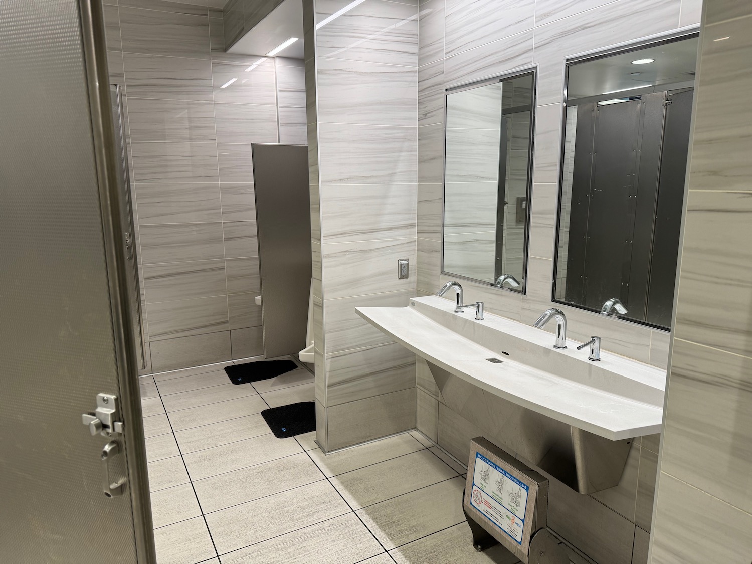 a bathroom with a sink and mirrors