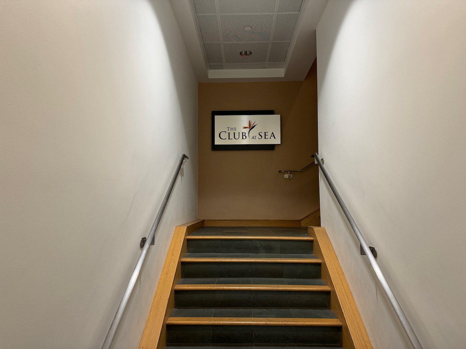 a staircase with a sign on the wall