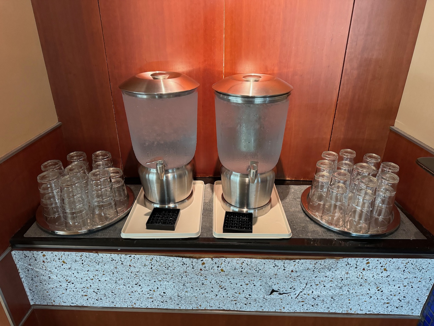 a water dispenser and glasses on a counter