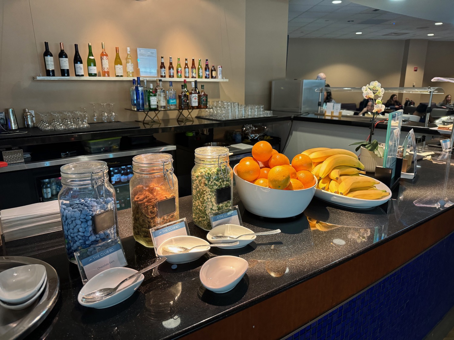 a counter with bowls of fruit and bowls of food