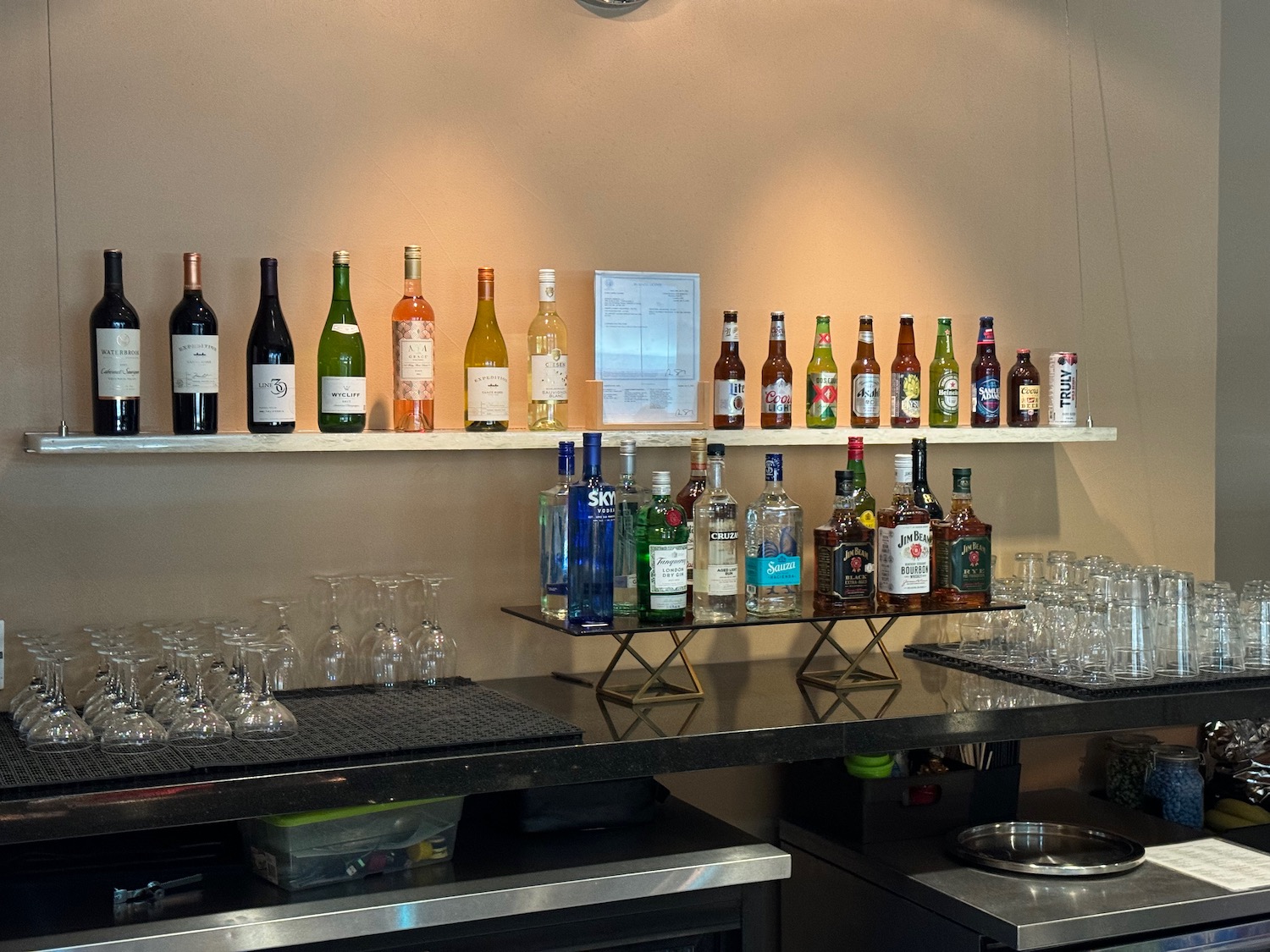 a shelf with bottles and glasses on it