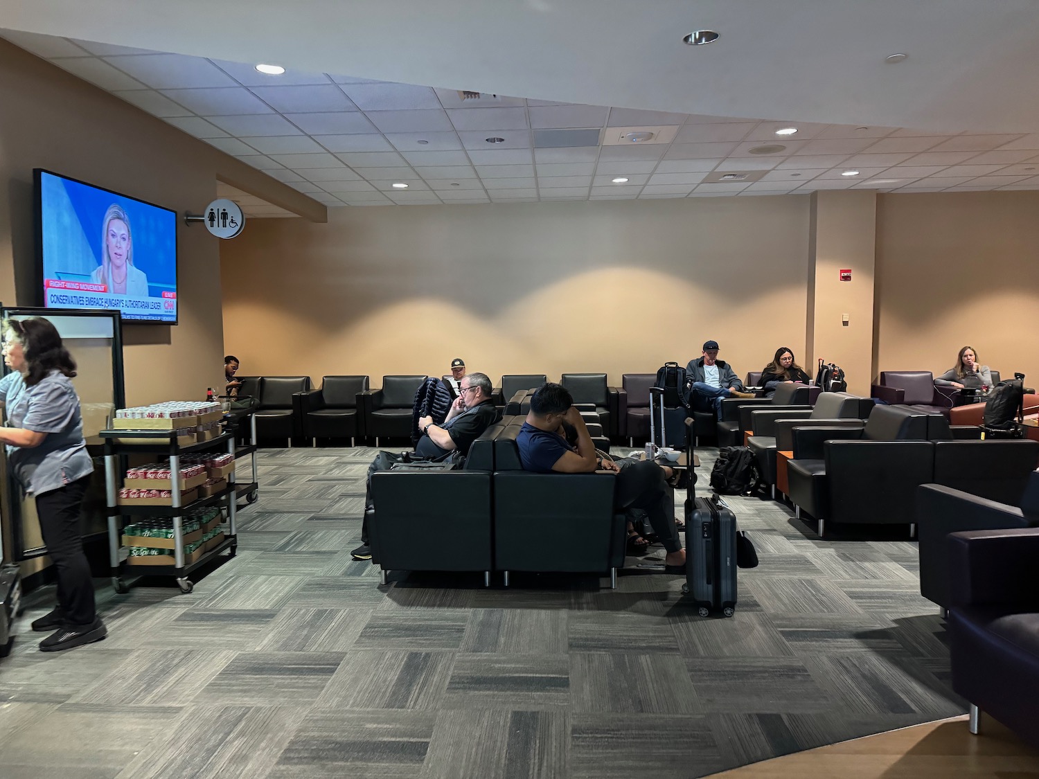 a group of people sitting in chairs in a waiting room